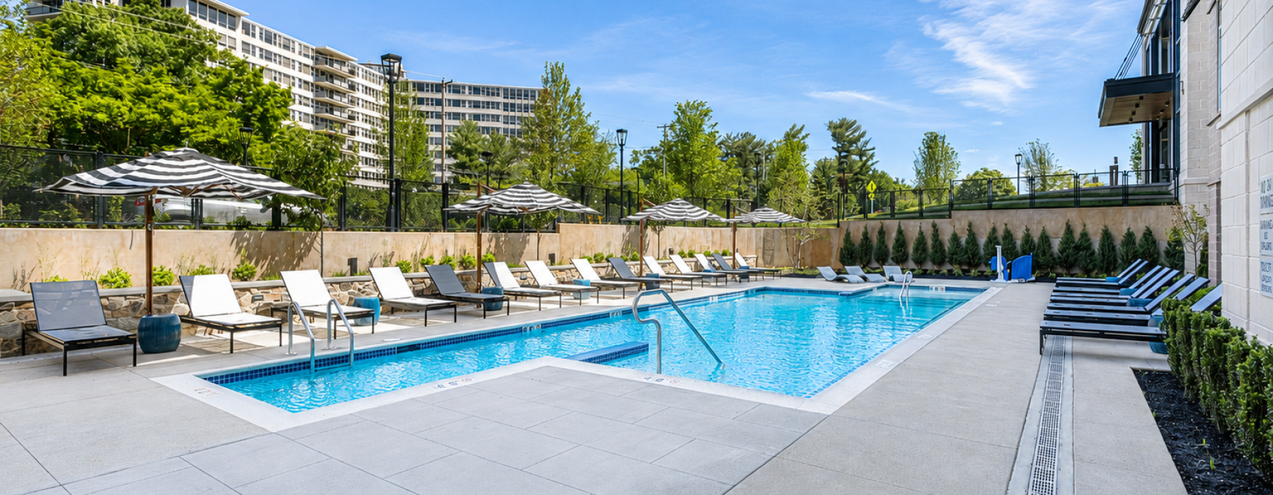 Resort-style swimming pool with lounge seating